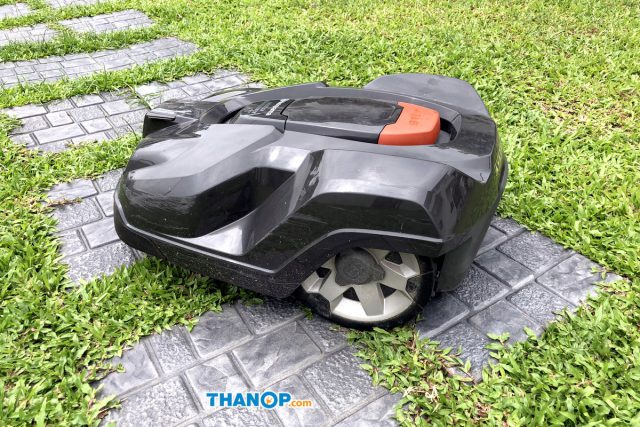 Robot Lawn Mower Working on Garden Tile